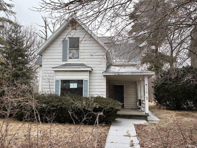 view of front of property featuring covered porch and a shingled roof