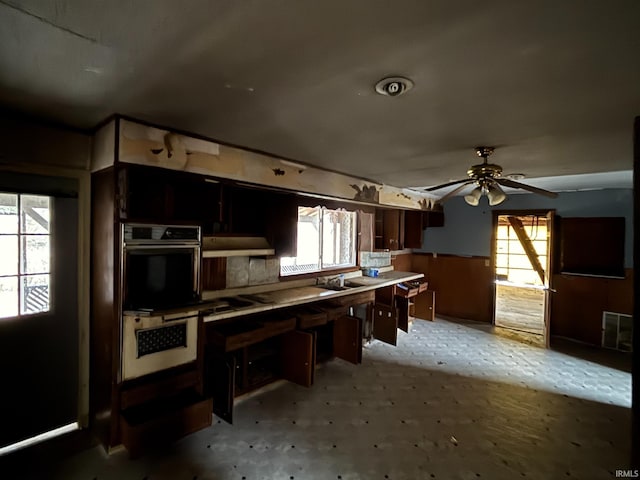 kitchen featuring visible vents, a ceiling fan, and a sink