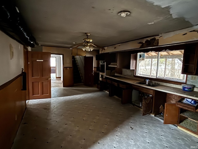 kitchen with light countertops, ceiling fan, and a sink