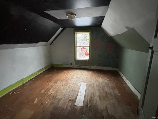 bonus room featuring vaulted ceiling, wood finished floors, and baseboards
