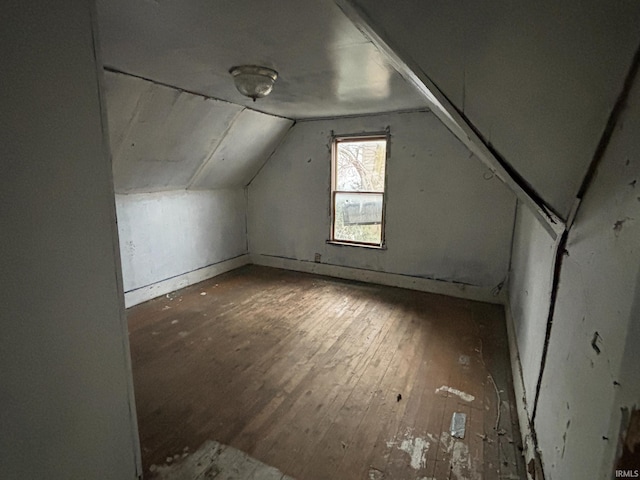bonus room with hardwood / wood-style floors and vaulted ceiling
