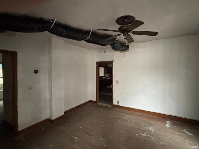 spare room featuring baseboards and a ceiling fan
