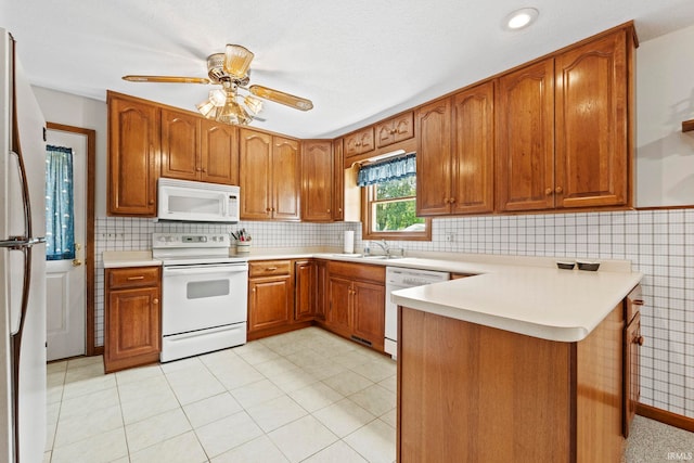 760 Ln 136 Turkey Lk, Hudson, IN 46747 - kitchen featuring a sink, white appliances, a peninsula, and brown cabinetry