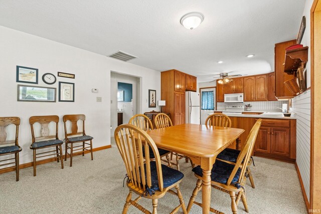 760 Ln 136 Turkey Lk, Hudson, IN 46747 - dining area with light carpet, baseboards, visible vents, and ceiling fan