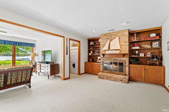 760 Ln 136 Turkey Lk, Hudson, IN 46747 - living room featuring light carpet, a brick fireplace, a textured ceiling, and built in shelves