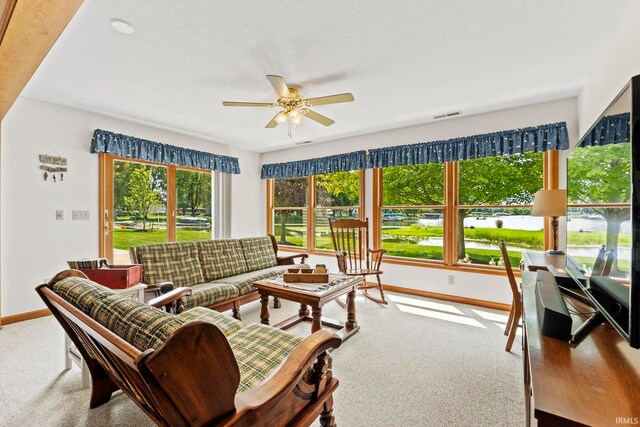760 Ln 136 Turkey Lk, Hudson, IN 46747 - living room featuring visible vents, a healthy amount of sunlight, a ceiling fan, and carpet floors