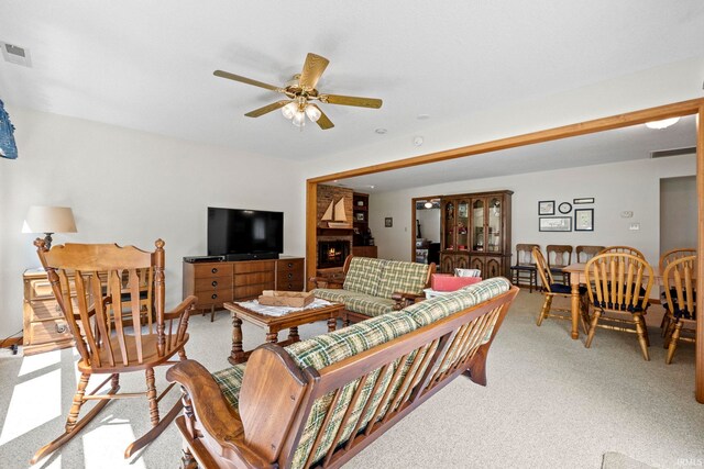 760 Ln 136 Turkey Lk, Hudson, IN 46747 - living room with a large fireplace, a ceiling fan, visible vents, and light carpet
