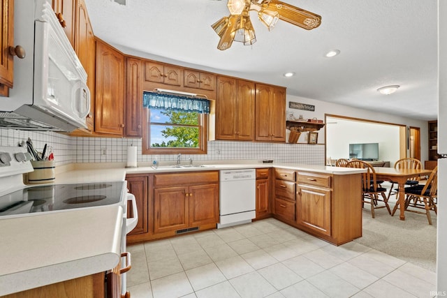 760 Ln 136 Turkey Lk, Hudson, IN 46747 - kitchen with white appliances, a peninsula, brown cabinets, and a sink