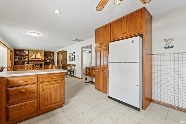760 Ln 136 Turkey Lk, Hudson, IN 46747 - kitchen featuring visible vents, brown cabinets, built in shelves, and freestanding refrigerator