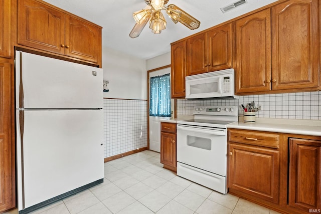 760 Ln 136 Turkey Lk, Hudson, IN 46747 - kitchen with visible vents, brown cabinets, a ceiling fan, white appliances, and light countertops