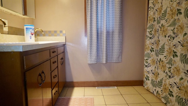 full bath featuring tile patterned floors, visible vents, baseboards, and vanity