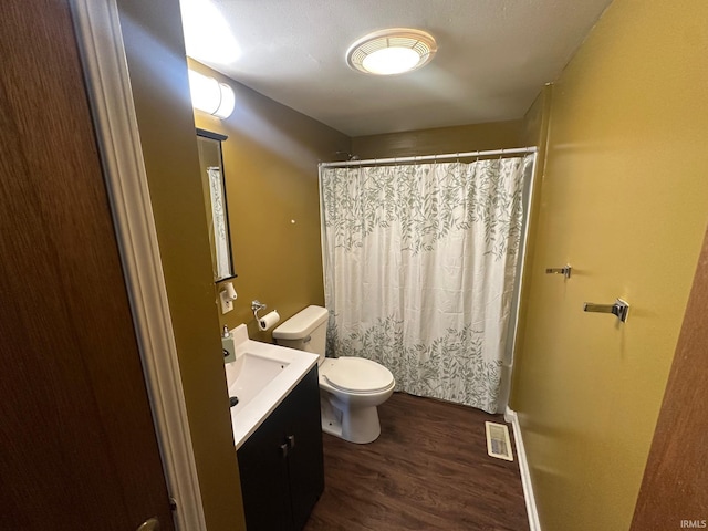 1130 N Lindsay St, Kokomo, IN 46902 - bathroom featuring visible vents, toilet, a shower with shower curtain, wood finished floors, and vanity