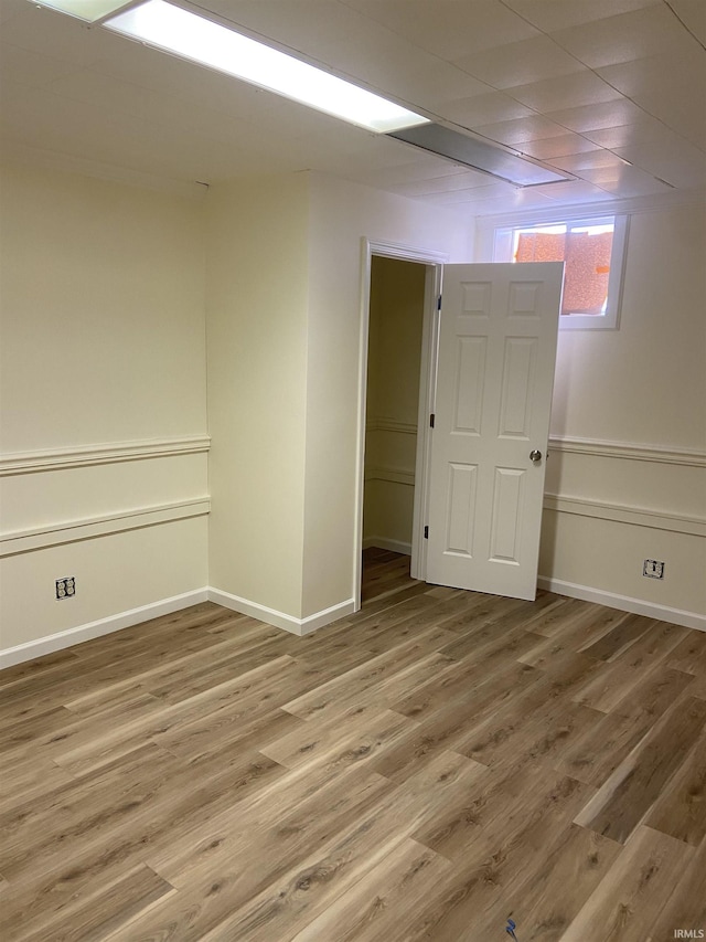 spare room featuring baseboards and wood finished floors