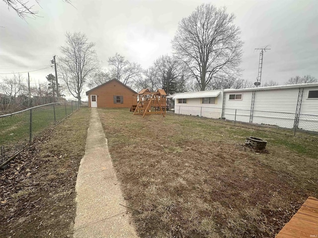 view of yard featuring a playground and a fenced backyard