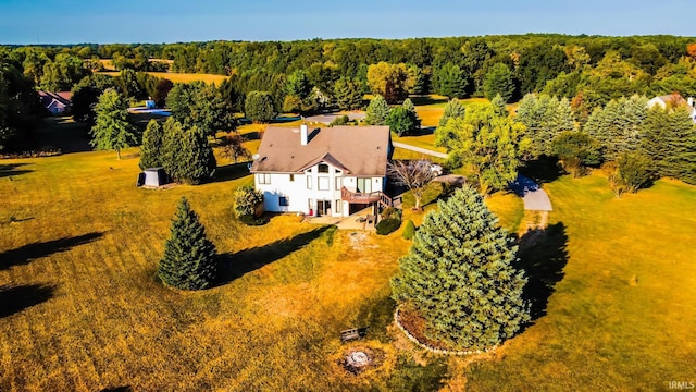 drone / aerial view featuring a view of trees
