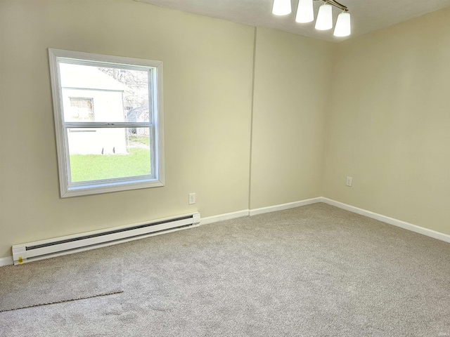 spare room with a baseboard radiator, carpet floors, and baseboards