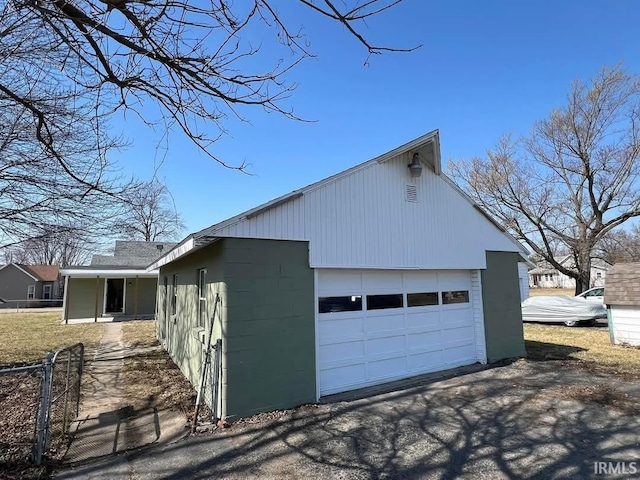 view of property exterior featuring concrete block siding and a garage