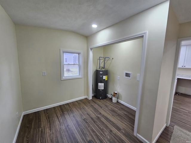 laundry room featuring water heater, laundry area, dark wood-type flooring, baseboards, and washer hookup