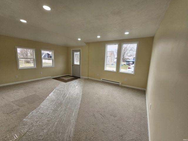 interior space featuring a baseboard heating unit, baseboards, and recessed lighting