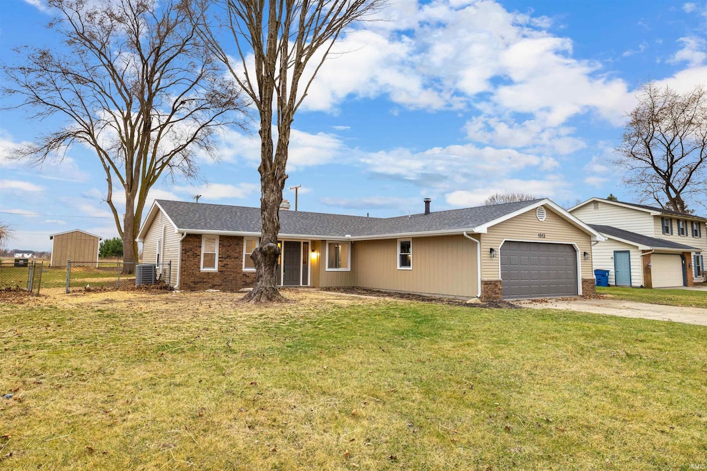 single story home with driveway, fence, a front yard, an attached garage, and brick siding