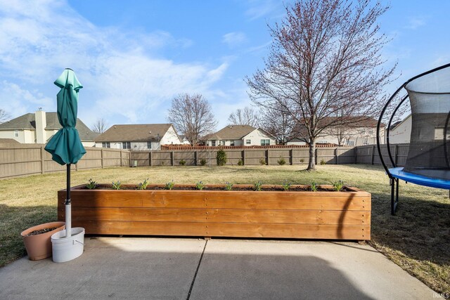 1814 Abbotsbury Way, Lafayette, IN 47909 - view of patio with a garden, a trampoline, a fenced backyard, and a residential view