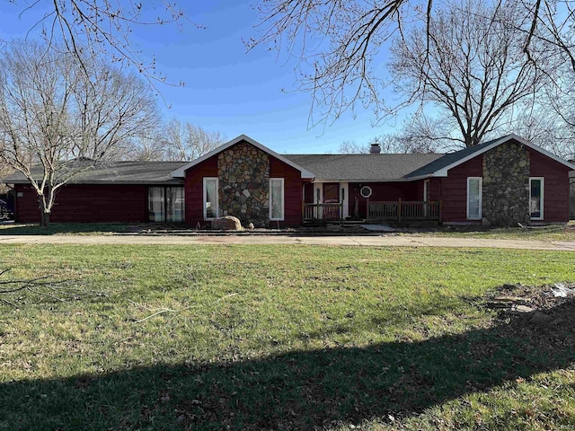 view of front of property with roof with shingles, a chimney, and a front lawn
