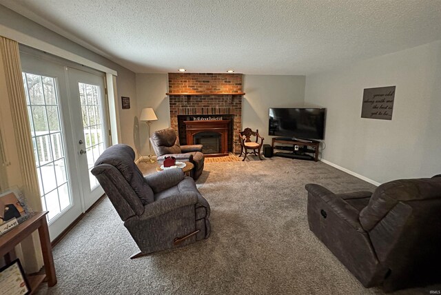 living room featuring baseboards, carpet floors, a fireplace, french doors, and a textured ceiling