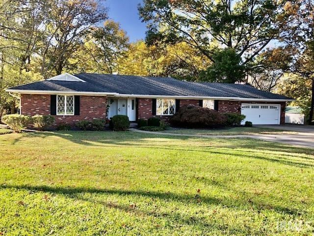 9420 Darmstadt Rd, Evansville, IN 47710 - ranch-style house featuring brick siding, driveway, a front yard, and an attached garage