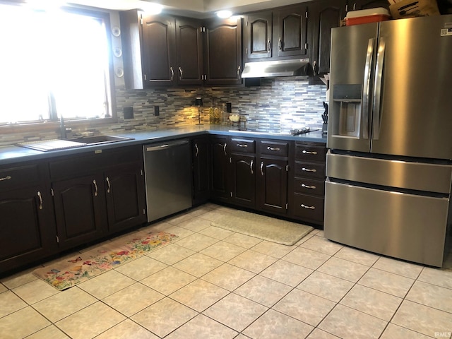 9420 Darmstadt Rd, Evansville, IN 47710 - kitchen with under cabinet range hood, backsplash, appliances with stainless steel finishes, and light tile patterned flooring