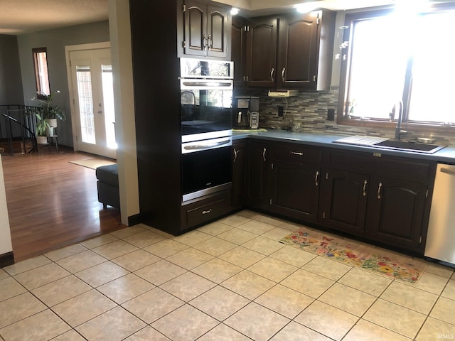 9420 Darmstadt Rd, Evansville, IN 47710 - kitchen featuring double wall oven, a sink, tasteful backsplash, light tile patterned floors, and dishwasher