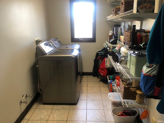 9420 Darmstadt Rd, Evansville, IN 47710 - clothes washing area with light tile patterned floors, baseboards, laundry area, and washer and clothes dryer
