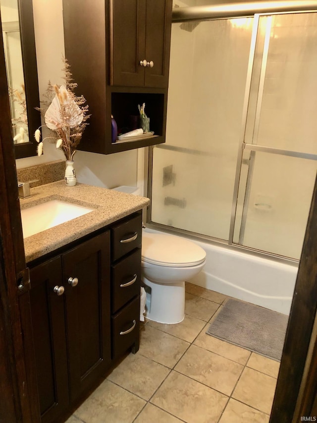 9420 Darmstadt Rd, Evansville, IN 47710 - bathroom featuring combined bath / shower with glass door, toilet, vanity, and tile patterned flooring