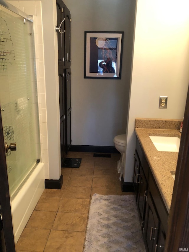 9420 Darmstadt Rd, Evansville, IN 47710 - full bath featuring baseboards, toilet, shower / bath combination with glass door, tile patterned floors, and vanity