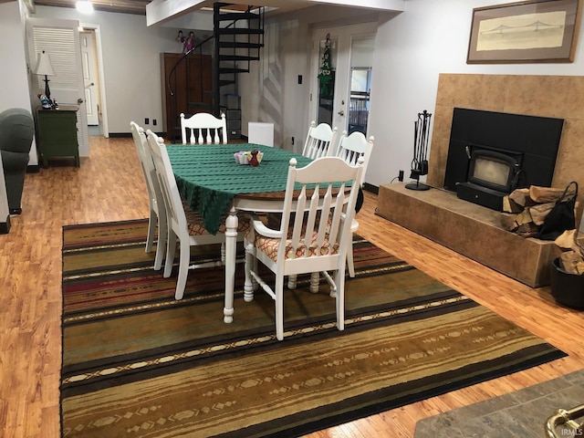 9420 Darmstadt Rd, Evansville, IN 47710 - dining space with a wood stove, baseboards, and wood finished floors