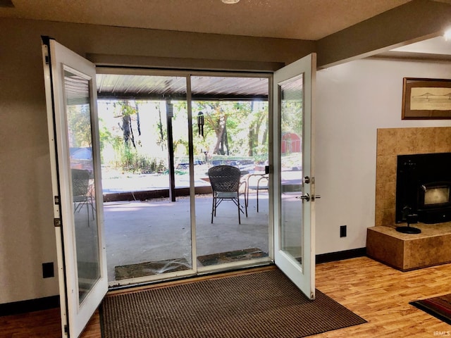 9420 Darmstadt Rd, Evansville, IN 47710 - entryway with a wood stove, wood finished floors, and baseboards