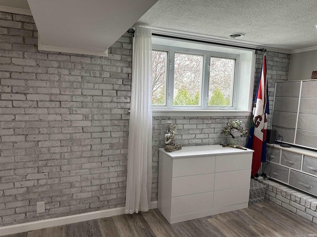 bathroom featuring wood finished floors, visible vents, crown molding, baseboards, and a textured ceiling