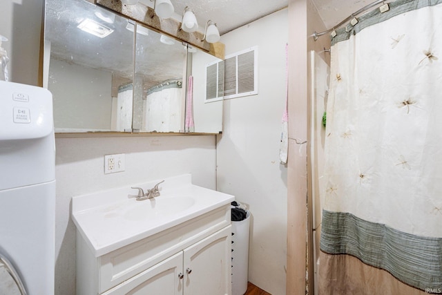 bathroom featuring visible vents and vanity