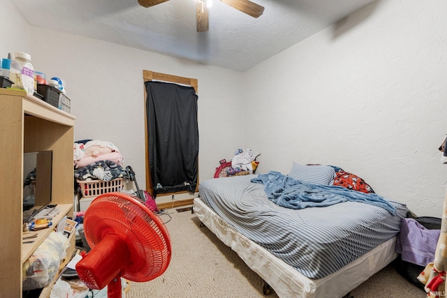 bedroom with a textured ceiling and ceiling fan