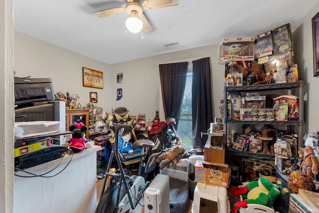 interior space with visible vents and ceiling fan