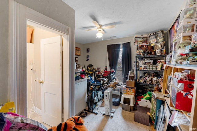 interior space featuring carpet floors, a textured ceiling, and ceiling fan