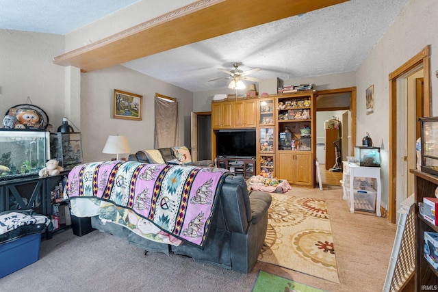 living area featuring light colored carpet, a textured ceiling, and ceiling fan