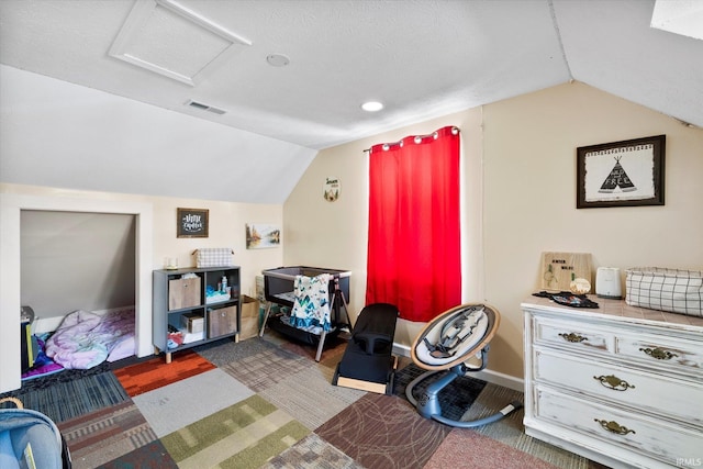recreation room with carpet, baseboards, visible vents, lofted ceiling, and attic access