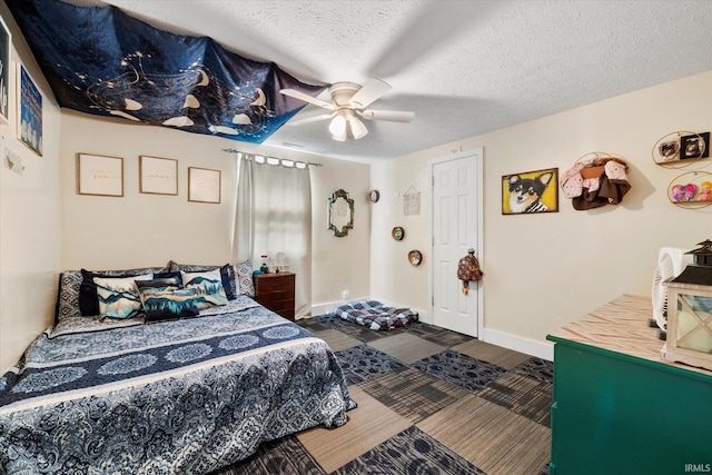 bedroom featuring wood finished floors, baseboards, a textured ceiling, and ceiling fan