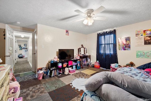 carpeted bedroom with a ceiling fan and a textured ceiling