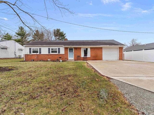 ranch-style home featuring brick siding, concrete driveway, a garage, and a front yard