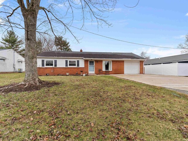 ranch-style home with a front lawn, concrete driveway, brick siding, and a garage
