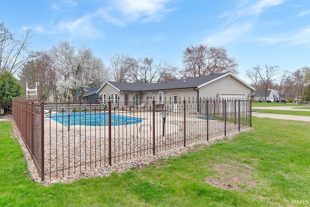 community pool with fence, a lawn, and a patio area