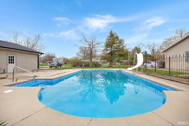 view of swimming pool featuring a water slide, fence, a patio area, and a fenced in pool