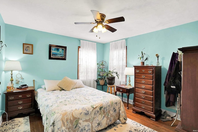 bedroom with a ceiling fan and wood finished floors
