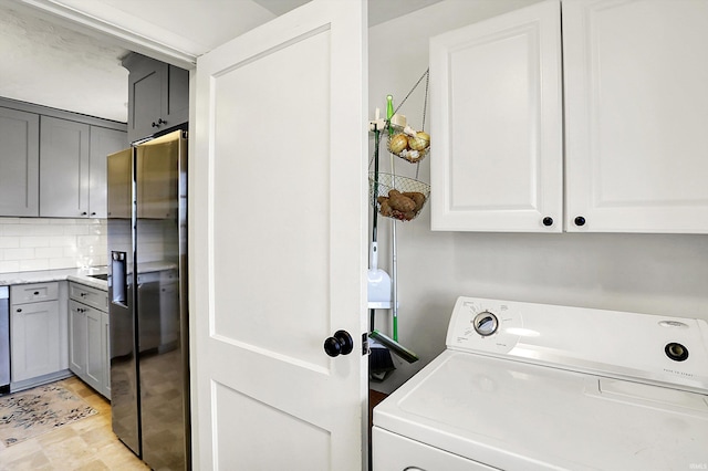 laundry room with cabinet space and washer / dryer